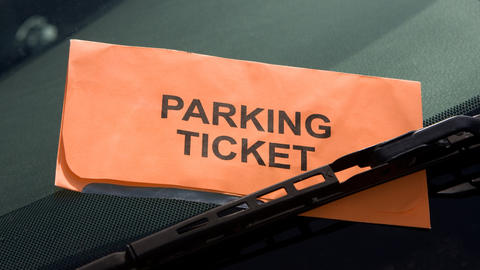 orange parking ticket on windshield
