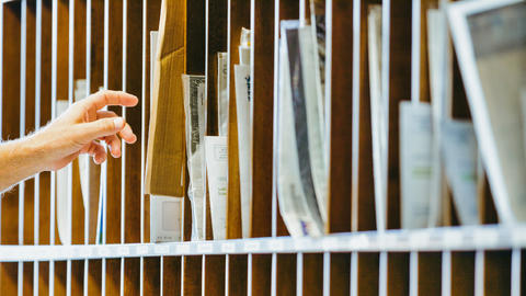 Someone sorting mail in mail slots
