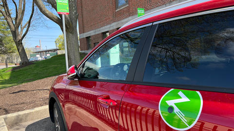 Electric zipcar parked and charging