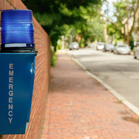 Emergency blue light on brick wall