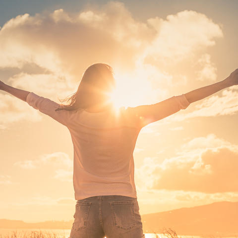 Person reaching up to the sky
