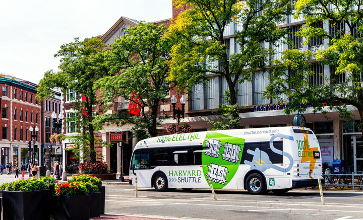 Harvard shuttle driving through Harvard Square
